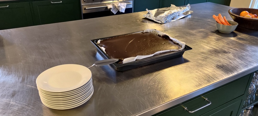 A cake i served at the office placed on a metal table